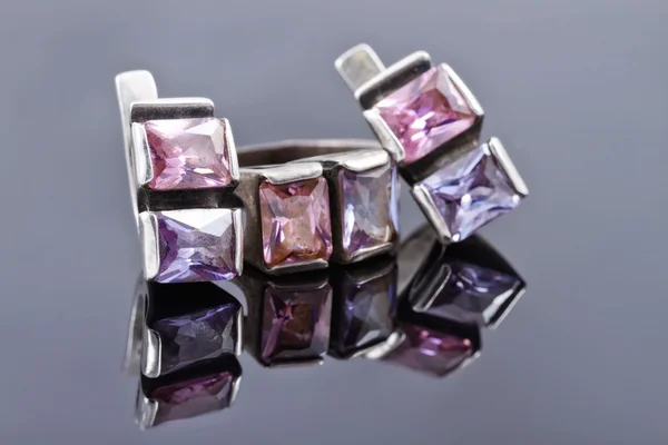 Carved silver ring with earrings with purple gemstones Stock Image