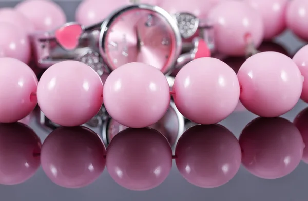 Large pink beads and pink women's watch — Stock Photo, Image