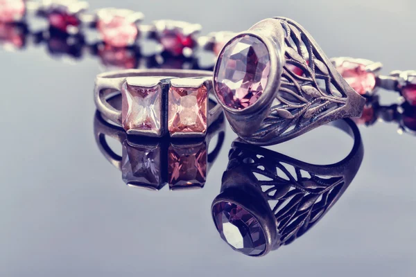 Carved silver ring with a blue gem and a silver bracelet — Stock Photo, Image