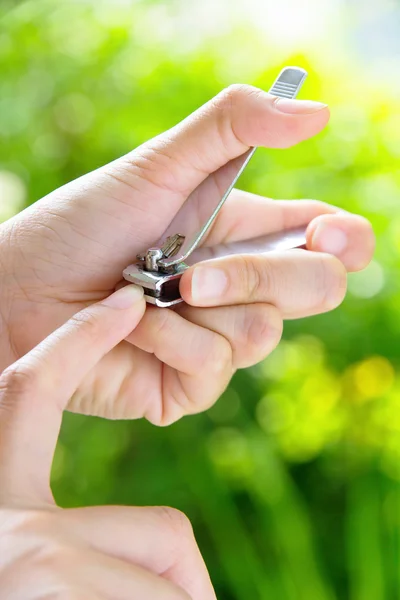 Hand manicure with nail clipper — Stock Photo, Image