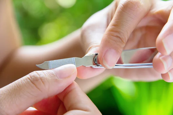 Hand manicure with nail clipper — Stock Photo, Image
