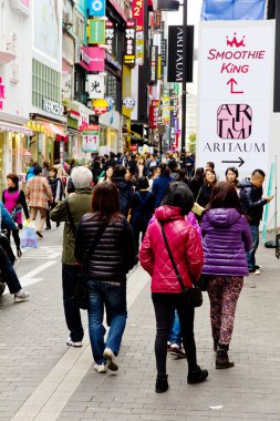 Young people shopping in the Myeongdong Shopping Street clipart