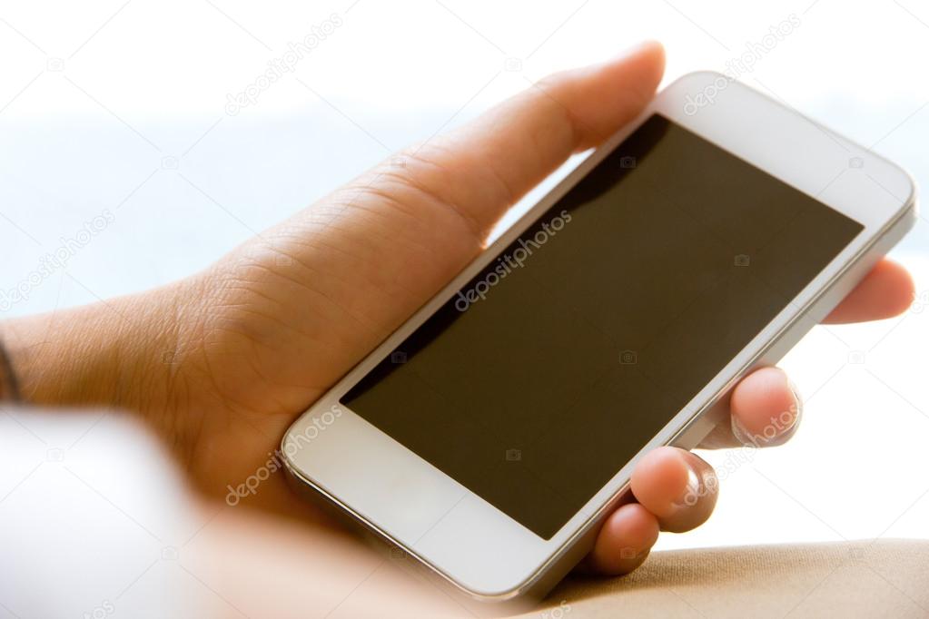 Woman hand holding a Smart Phone