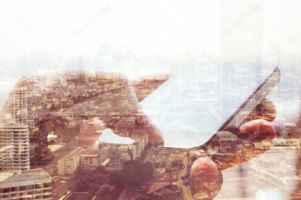 Double exposure of cityscape and smart phone