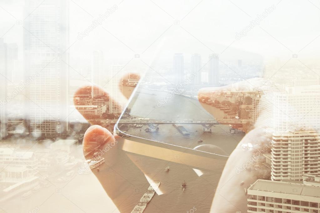 Double exposure of cityscape and smart phone