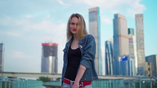 Young blonde woman walks on the railroad tracks in the city — Stock Video