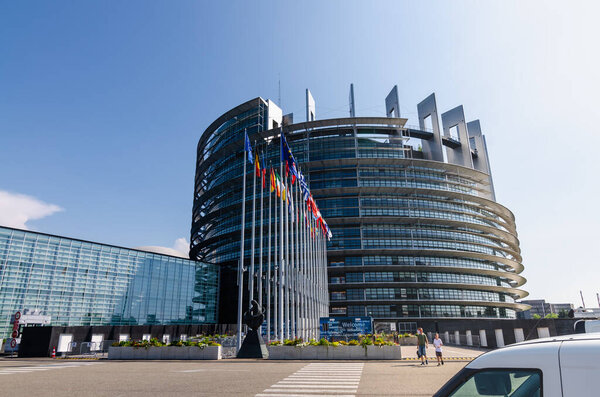 Strasbourg, France. August 2019.The entrance to the modern seat of the European parliament. A row of flagpoles with the flags of the member states of the European Union welcomes those who enter.