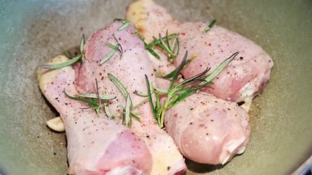 鍋で茶色の鶏の足のクローズアップ映像とコショウで味付け ローズマリー 塩とニンニク — ストック動画