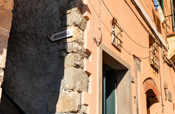 Vernazza, Liguria, Italy. June 2021. From the center of the village a plaque indicates the direction for the path called via dell'amore in the direction of Monterosso. Famous tourist destination.