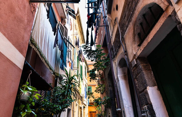 Vernazza, Liguria, Italy. June 2021. In the secondary alleys, clothes hung out to dry and potted plants characterize the village. Sunny day.