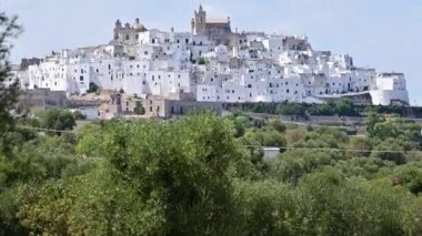 Beyaz şehrin inanılmaz görüntüleri: Ostuni, Puglia, İtalya. Bir tepenin tepesinde, beyaz rengiyle karakterize edilen tarihi merkez, çevresindeki kırsal kesimden göze çarpar..
