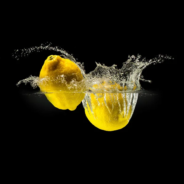 Grupo de frutas frescas que caen en el agua con salpicaduras sobre fondo negro — Foto de Stock