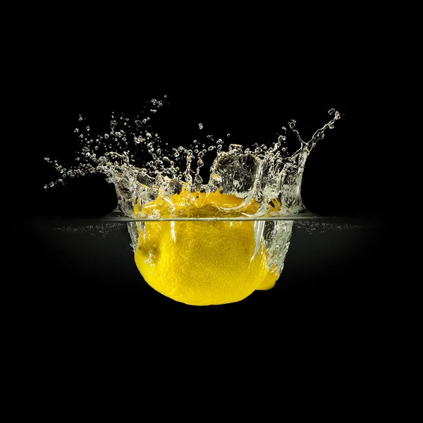 Fresh fruits falling in water with splash on black background — Stock Photo, Image
