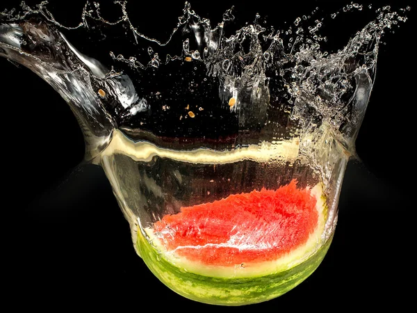 Fresh melon falling in water with splash on black background — Stock Photo, Image