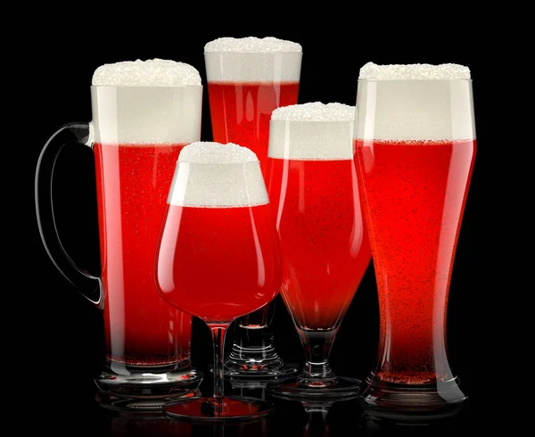 Set of fresh stout beer glasses with bubble froth isolated on black background.