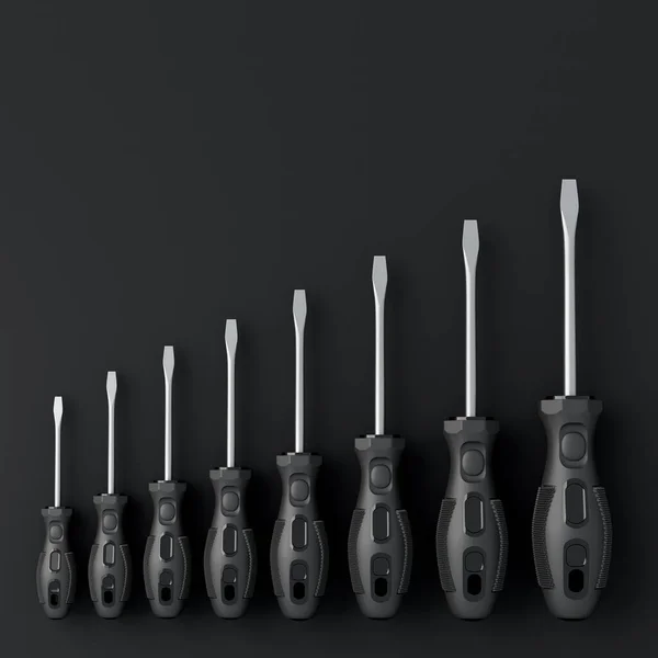 Top view of monochrome screwdrivers on black background — Stock Photo, Image