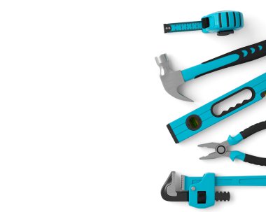 Top view of green construction tools for repair and installation on white