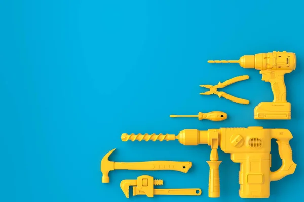 Vista superior de ferramentas de construção monocromáticas para reparo em azul e amarelo — Fotografia de Stock