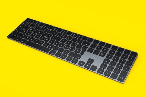 Moderne Computertastatur Aus Dunklem Aluminium Mit Ziffernblock Auf Gelbem Hintergrund — Stockfoto