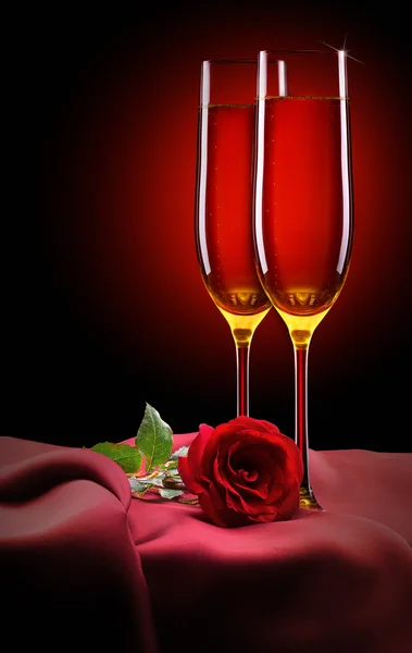 Glass of champagne and rose on black — Stock Photo, Image