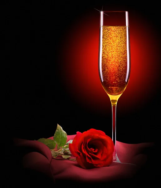 Glass of champagne and rose on black — Stock Photo, Image