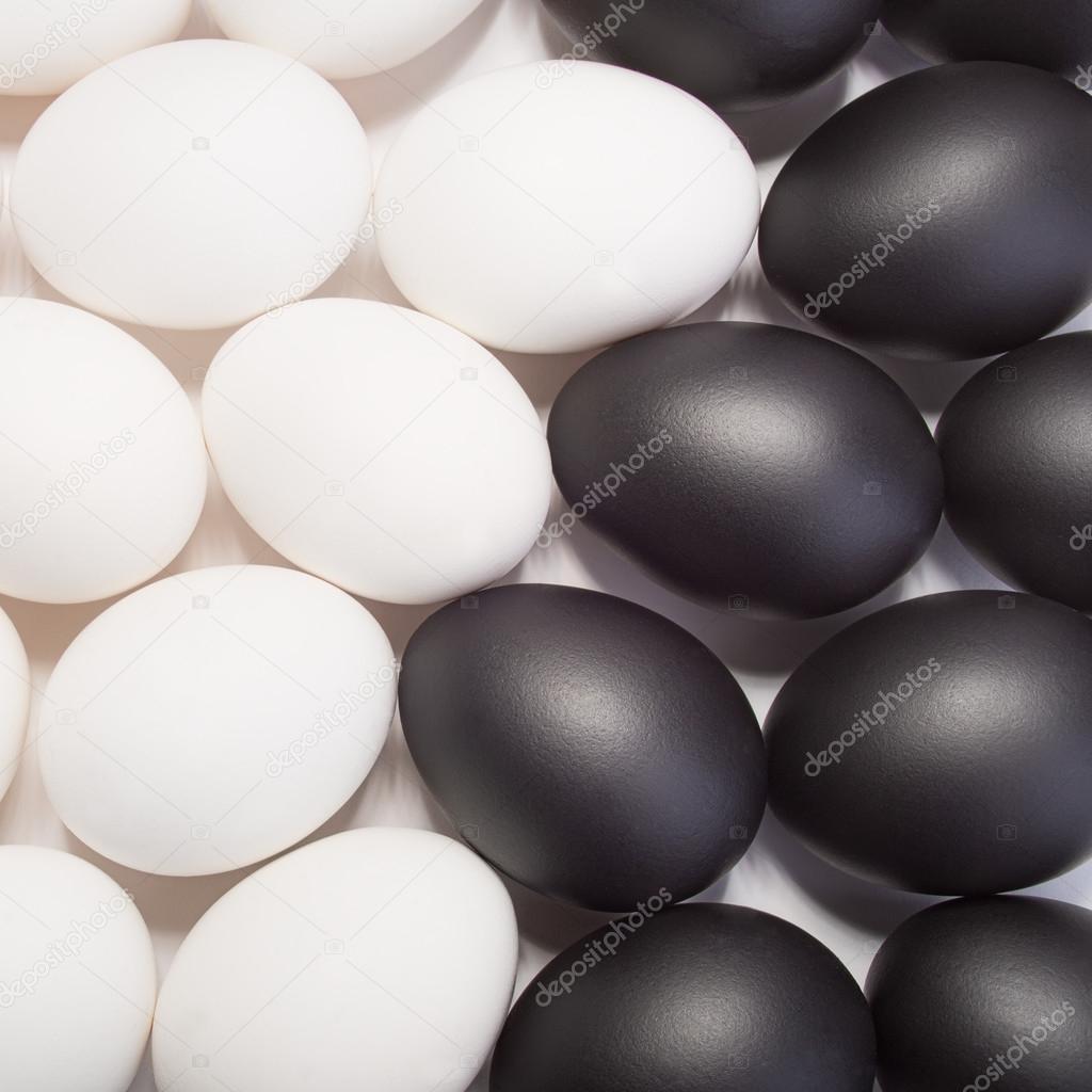 many of black and white eggs as background