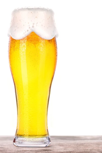 Frosty glass of light beer on a wooden table — Stock Photo, Image