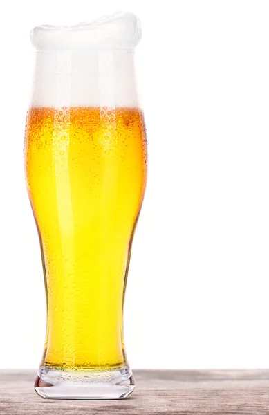 Frosty glass of light beer on a wooden table — Stock Photo, Image