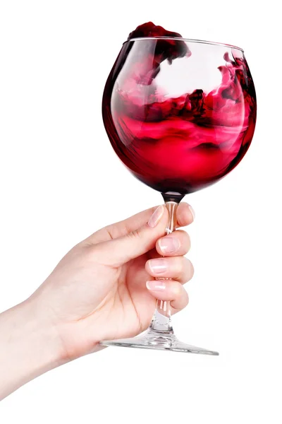 Glass of red wine with splashes in hand isolated — Stock Photo, Image