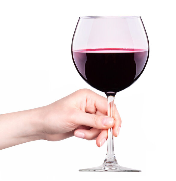 Glass of red wine with splashes in hand isolated