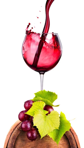 Glass of red wine on a wooden barrel with grape — Stock Photo, Image