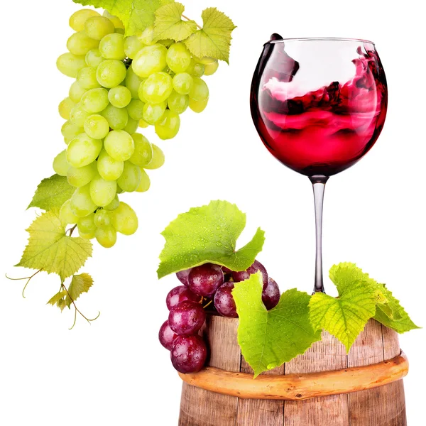 Glass of red wine with grape on a wooden barrel — Stock Photo, Image