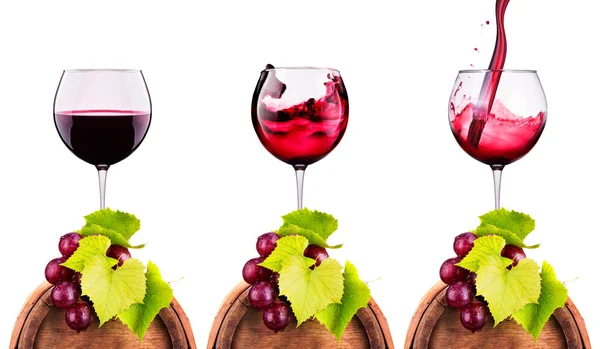 Glass of red wine with grape on a wooden barrel — Stock Photo, Image