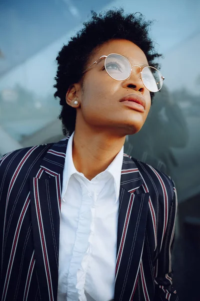 4k. Okouzlující Afroameričanka v moderním pruhovaném obleku a hledící nikam. Podnikatelka nebo studentka. Zavřít. Portrét. — Stock fotografie