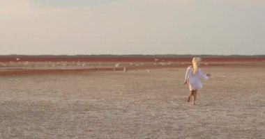 Sahada koşan ve dönen güzel kız. Kırsal kesimin özgürlüğünden heyecan duyan genç bir bayan. Doğa. Özgürlük kavramı. Yavaş çekim videosu