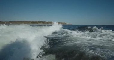 Küçük beyaz yolcu gemisi denizde seyrediyor. Yatın dikiz aynası. Köpüklü dalga izi. 4K video. Yavaş çekim..