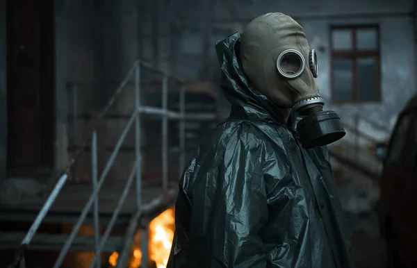 Scientist dosimetrist radiation supervisor in protective clothing and gas mask explores the danger zone. Fire. Close-up