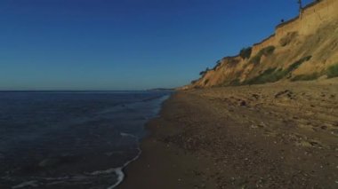 Akdeniz kıyısı yamaçlarında sarı kum ve turkuaz deniz ile ilerleyen 4 km yüksekliğinde bir hava manzarası var..
