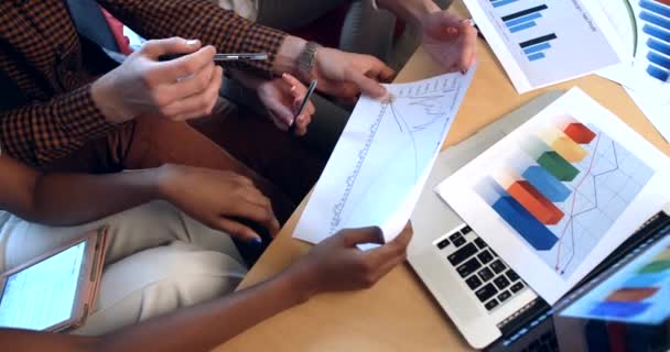 Close-up above view of three hands of multicultural businesspeople arguing while working with graphics and diagrams. Team work in the office. — Stock Video