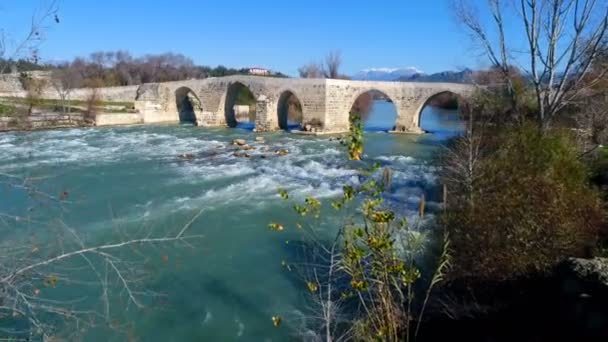 Antalya ili, Türkiye. Eurymedon Nehri üzerindeki eski tarihi Seljuk köprüsünün üzerinde uçan helikopter. Yavaş çekim, 4k. — Stok video