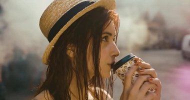 Dağlarda görev. Kız ateşin önünde kahve içiyor ve gökyüzünde rüya gibi görünüyor. Yaz zamanı.