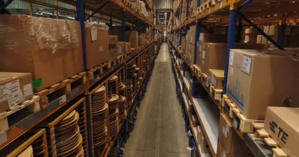 Automotive inductry. The warehouse of car factory. Travelling camera between racks with paperboxes full of electrical wirings, cables and other vehicle goods. — Stock Video