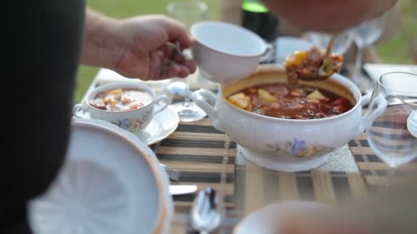 Heerlijke vleessoep wordt uit een pan op een bord gelegd. Bograch. Borsch — Stockvideo