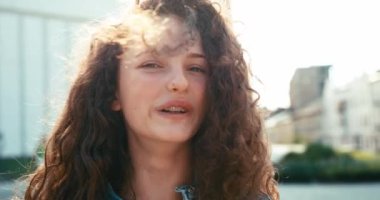 Çekici, gülümseyen kız yüzünden kara kıvırcığı uçuyor. 4k görüntü.