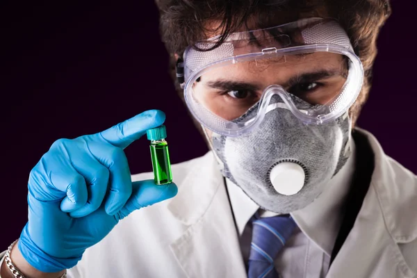Holding a green vial — Stock Photo, Image