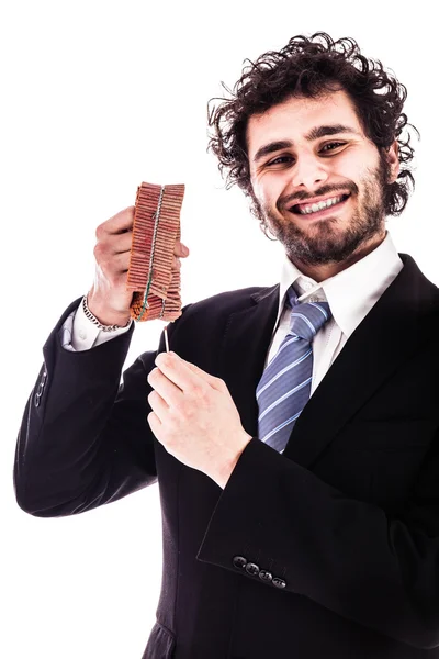 Sonriente hombre de negocios encendiendo petardos rojos —  Fotos de Stock