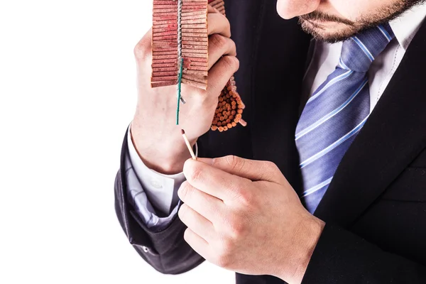 Businessman lighting fire crackers — Stock Photo, Image