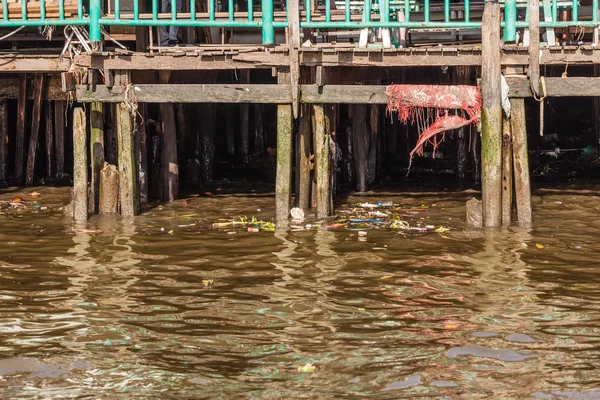 Stilts and polluted water — Stock Photo, Image