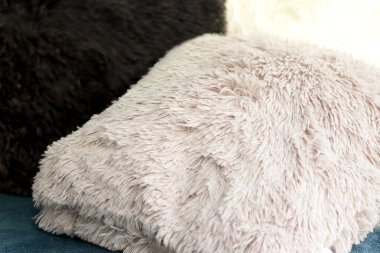 Renkli kabarık yastıklar, ev dekorasyonu, koltukta beyaz siyah gri yastıklar, kürk tekstil.  