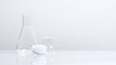 Laboratuvar masasında beyaz pullu kimyasal madde var. Cetyl esters cila, OTC ürünlerinde ve güncel ilaç ürünlerinde kullanılan kimyasal maddeler..